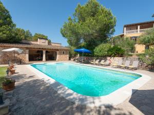 a swimming pool in a yard with a house at Finca s'Aguait in Portocolom