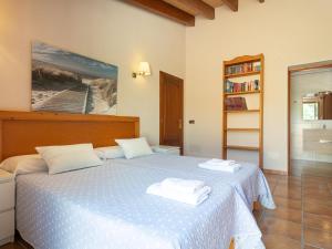 a bedroom with a bed with two towels on it at Finca s'Aguait in Portocolom +32 photos