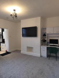 a living room with a flat screen tv on a wall at Kai Homes in Ashington in Ashington