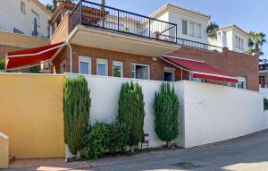 a house with a white fence and trees at Lovely Home In Almuñecar With Ethernet Internet in Almuñécar