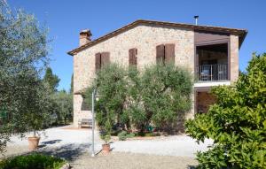 une vieille maison en briques avec un arbre devant elle dans l'établissement 1 Bedroom Nice Apartment In Casole D'elsa, à Pieve a Scuola 12 autres photos