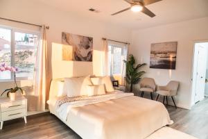 a bedroom with a large bed and two windows at New House in the Palisades Hills in Albuquerque
