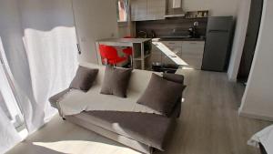 a living room with a couch and a kitchen at MilanoValery3 in Milan