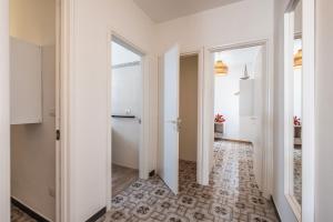a corridor with white walls and a hallway with a hallway at Golden Bay Lux House in Torre Lapillo +21 photos