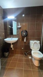 a bathroom with a toilet and a sink at Walk Inn in Miri +54 photos