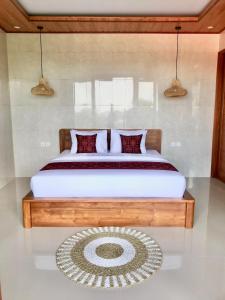 a bedroom with a large bed with a rug at Heri house ubud in Ubud +36 photos