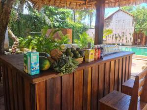 a counter with fruits and drinks on a wooden fence at Ong Lang Garden Resort in Phu Quoc