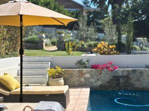 an umbrella and chair next to a swimming pool at Ginger Lake Wilderness in Wilderness +16 photos