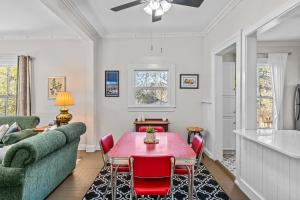 a living room with a table and a couch at Lenoir Cottage w covered patio and fire pit in Athens
