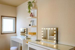 a dressing room with a mirror and a window at Tokinoma Furano in Furano +165 photos