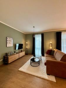 a living room with a couch and a table at Zentral und Stilvoll Nahe Kurpark und Bali Therme in Bad Oeynhausen +16 photos