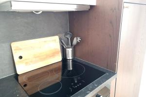 a kitchen counter with a vase with utensils in it at Le Rêve Suspendu in Le Havre