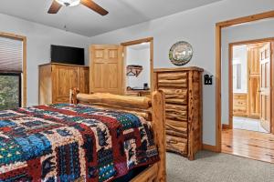 a bedroom with a bed and a dresser at The Cabin Kingdom Hot tub Fire Pit in Blairsville