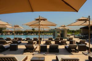 a group of chairs and umbrellas next to a pool at Hotel Meteo Kakheti in Ruispiri +22 photos