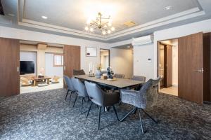 a dining room with a table and chairs at b&難波1号店 in Osaka