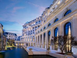 a large building with a canal in front of it at Sofitel Shanghai Hongqiao in Shanghai