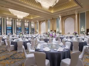 a ballroom with tables and white chairs and a room filled with tables and chairs at Sofitel Shanghai Hongqiao in Shanghai +121 photos