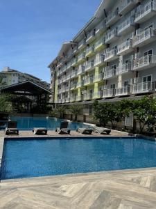 a swimming pool in front of a building at Mira's condo unit at Amani grand residences near Mactan Int'l Airport in Pusok