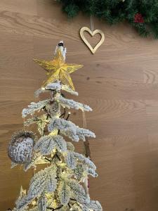 a christmas ornament of a pine tree with a heart at La Pulchella in LʼAquila