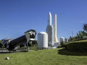 a slide in a park with a building in the background at Ibis Styles Toulouse Blagnac Aéroport in Blagnac