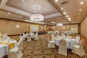 a banquet hall with white tables and white chairs at Quality Inn & Conference Centre in Midland +32 photos
