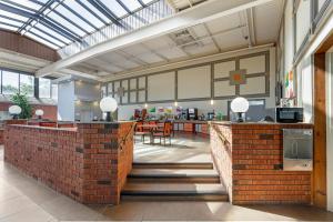 a large room with a brick wall and a restaurant at Quality Inn & Conference Centre in Midland