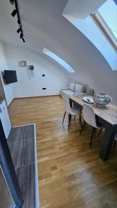 a living room with a table and chairs and a couch at Spring 2 in Petrovaradin