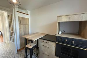 a kitchen with a stove and a wooden counter top at Le ciel havrais in Le Havre