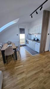 a living room with a table and a kitchen at Spring 2 in Petrovaradin