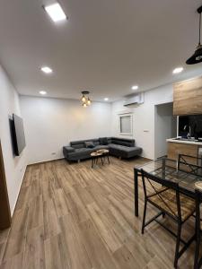 a living room with a couch and a table at Modern apartment 2 Barcelona in Santa Coloma de Gramanet