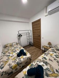 a bedroom with two beds and a door at Modern apartment 2 Barcelona in Santa Coloma de Gramanet