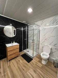 a bathroom with a shower and a toilet and a sink at Modern apartment 2 Barcelona in Santa Coloma de Gramanet