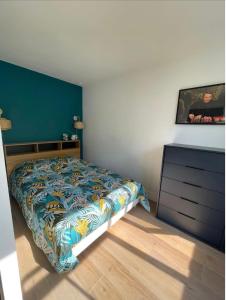 a bedroom with a bed and a dresser at The Blue Jack - studio near the Casino in Le Havre