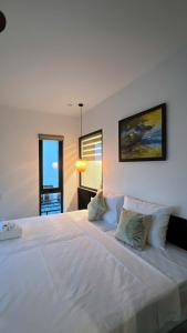 a large white bed in a room with a window at Betel Hoi An Homestay in Cam Thanh +24 photos
