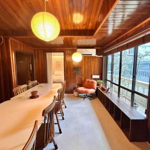 a large dining room with a long table and chairs at SLOW GWANGAN hotel in Kwangan-dong +70 photos