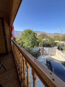 a balcony of a cabin with a view of the mountains at Zghapari Wooden Mountain Lodge in Aspindza +71 photos