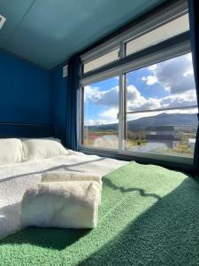 a bedroom with a bed and a large window at Rusutsu Ski Stay111 in Rusutsu