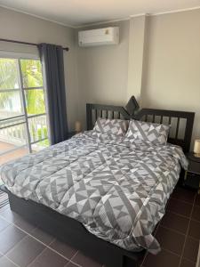 een bed met een zwart-wit dekbed in een slaapkamer bij Villa Maris - Blue mango residence, Mae Phim in Ban Tha Fat +38 foto's