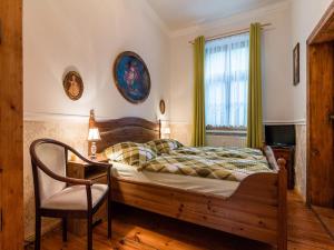a bedroom with a bed and a chair and a window at Ferienwohnungen Romantika in Potsdam +44 photos