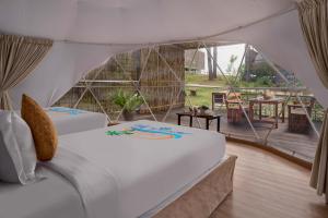 a bedroom with two beds in a tent at Koh Sdach Resort by EHM in Kaoh Sdach