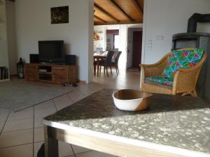 a kitchen and living room with a table and a tv at Ferienhaus Unteres Hart in Gomadingen
