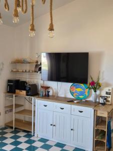 a living room with a large tv on the wall at Golden Dune View in Torre Dei Corsari