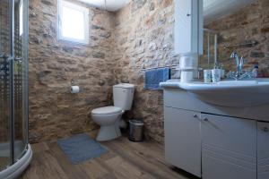a bathroom with a toilet and a sink at Rohami in Kalentzi +5 photos