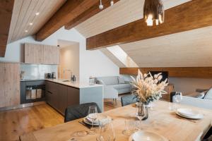 a kitchen and living room with a wooden table at San Bernardino Alpine Apartments in San Bernardino