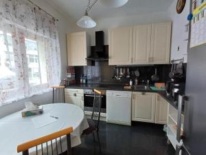 a kitchen with white cabinets and a white table at Wohnung in Hürth bei Köln in Hürth