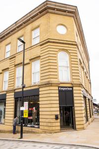a building on the corner of a street at Firdaus Central Huddersfield Apartments in Huddersfield