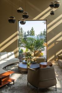 a living room with a couch and a table at Saint Sofia Golf Club, Hotel and SPA in Robertowo