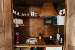 a kitchen with a sink and a microwave at Castello di Pasturana in Pasturana +63 photos