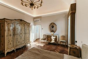 a living room with a large wooden cabinet and a mirror at Castello di Pasturana in Pasturana