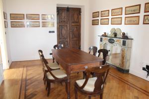 a dining room with a wooden table and chairs at Castello di Pasturana in Pasturana